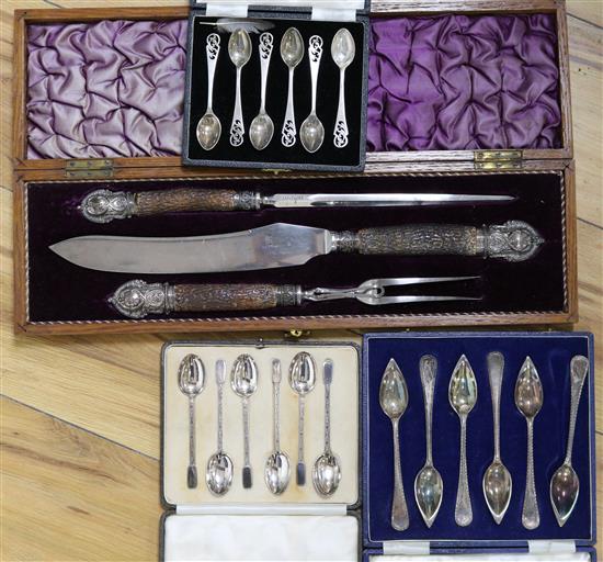 Three cased sets of silver spoons including grapefruit and a cased carving set.